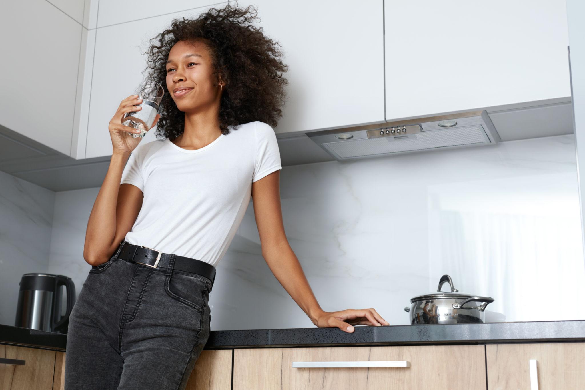Homeowner enjoying fresh water in her kitchen
